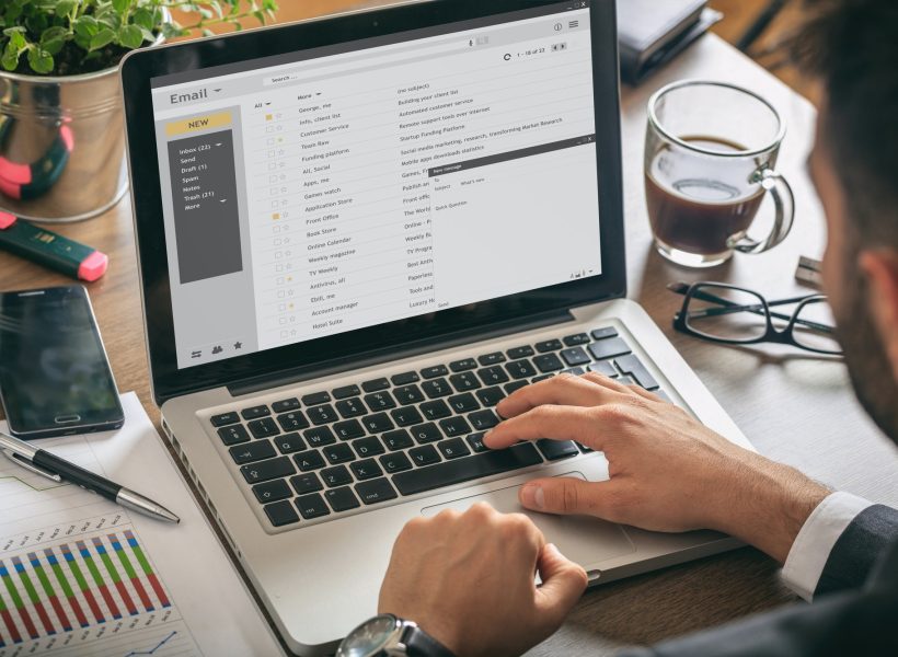 emails-list-on-a-laptop-screen-office-background