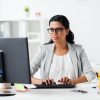happy-businesswoman-with-computer-at-office